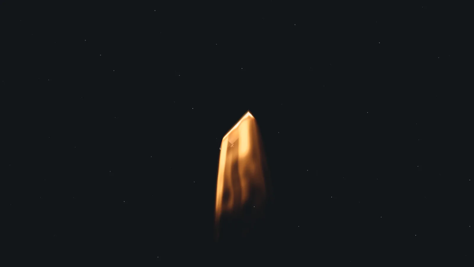 A capsule wrapped in orange reentry plasma against a black sky